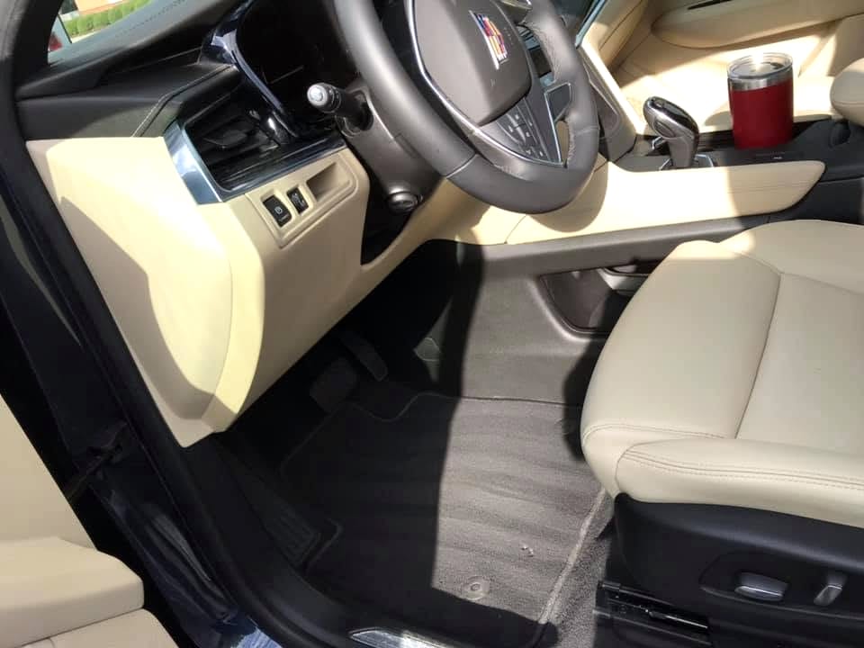 Freshly detailed car interior with clean leather seats and shampooed carpet
