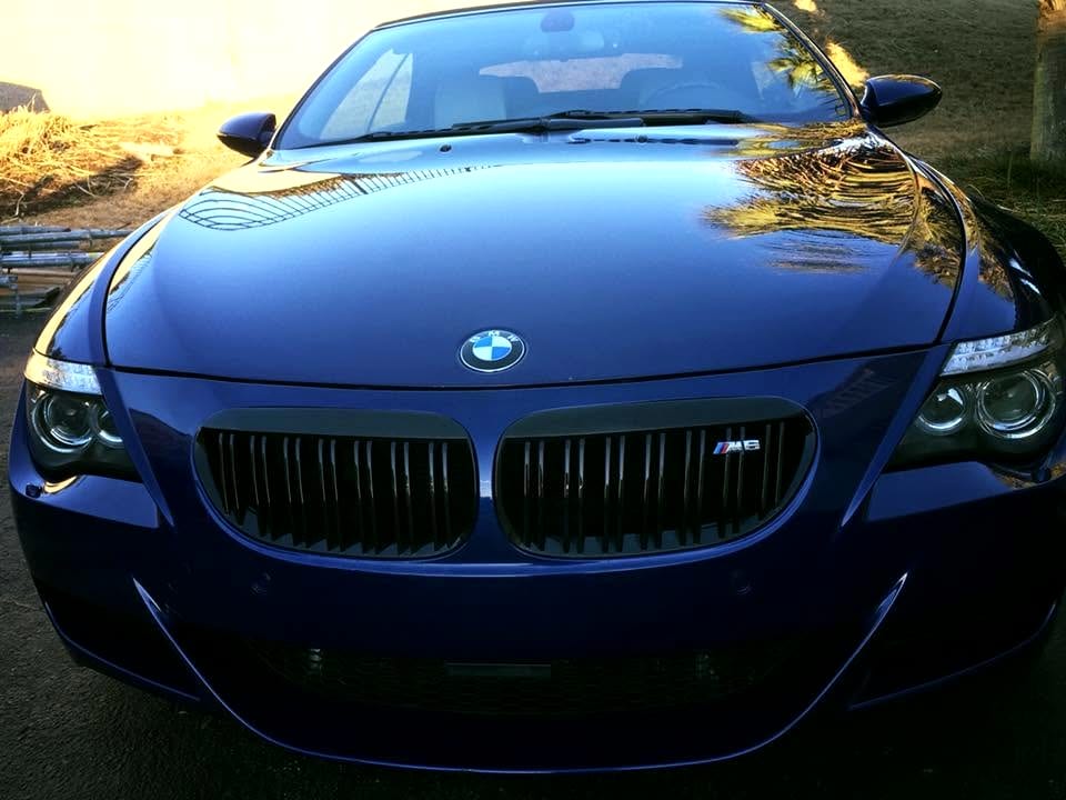 Restored, crystal-clear headlights on the front of a blue sports car