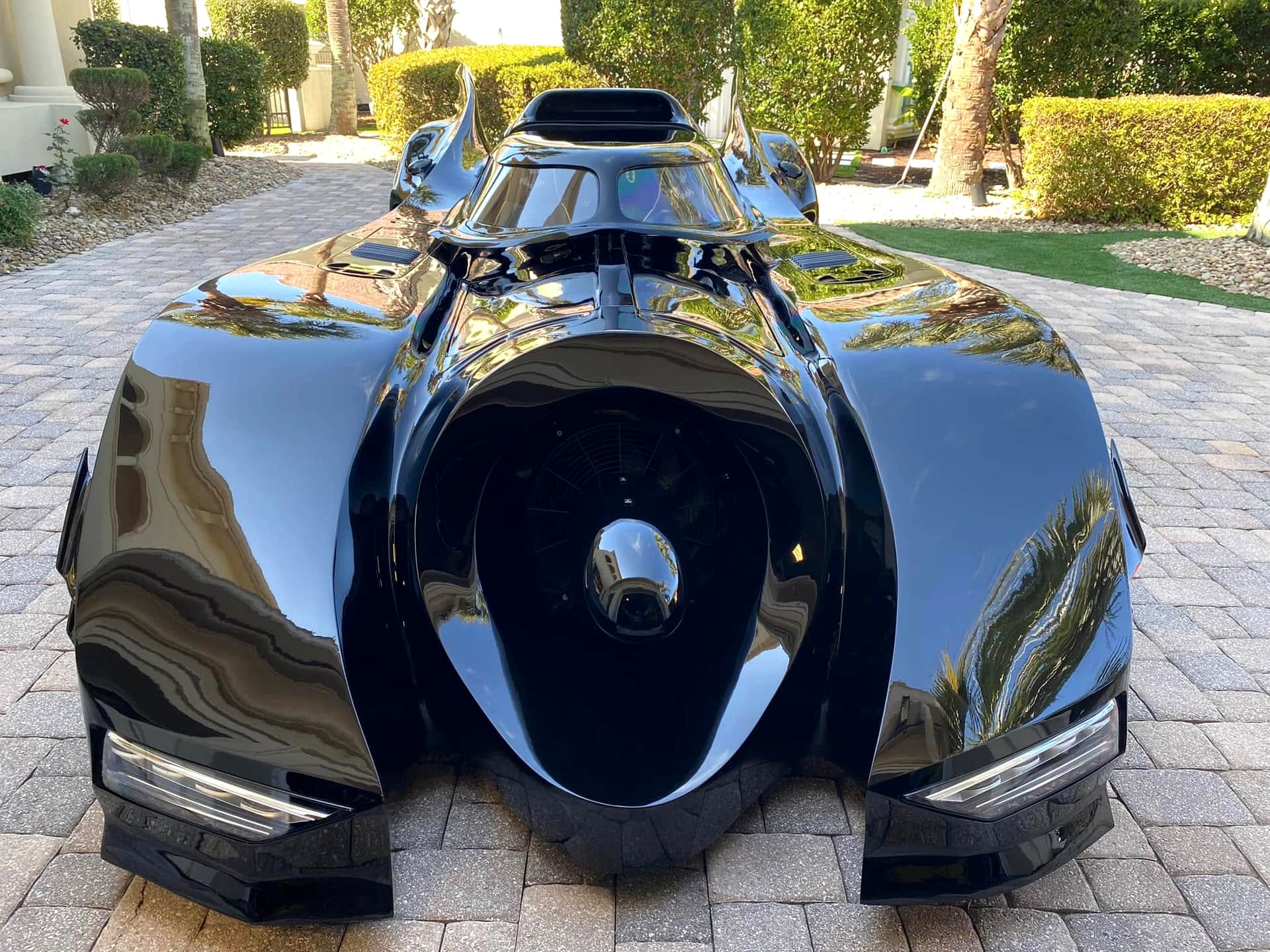 Mirror-finish black custom vehicle detailed to a showroom shine in a Myrtle Beach driveway
